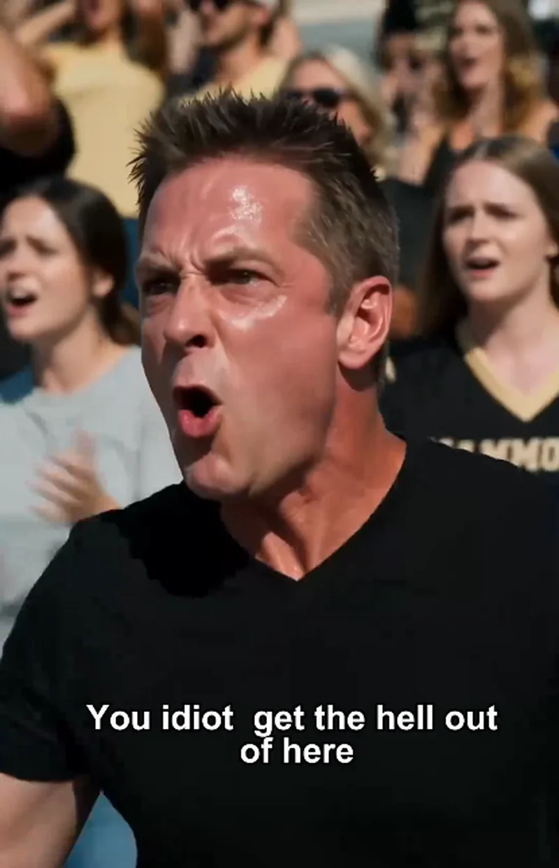 An angry middle-aged fan in a black shirt yells from the stands, subtitle reads 
