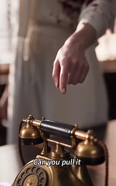 Close-up of a brass rotary phone, hand hovering, subtitle: Can you pull it