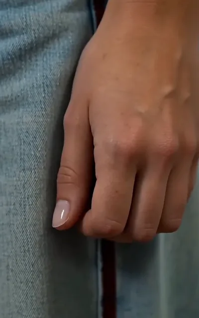 The free episodes' most-talked-about shot: a manicured hand resting on denim jeans, fingers curled at the waistband, close-up