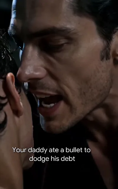 Cold-eyed older man in black leans in close: "Your daddy ate a bullet to dodge his debt"