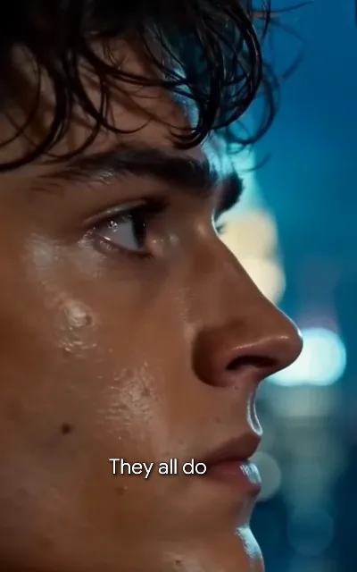 Julian's bruised side profile in blue night bokeh: "They all do"